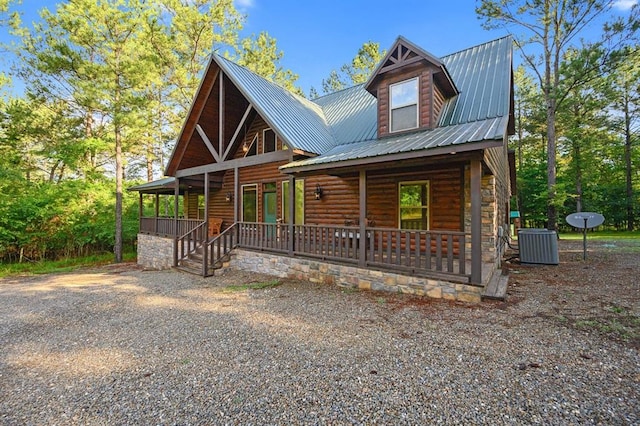 cabin with a porch and central air condition unit