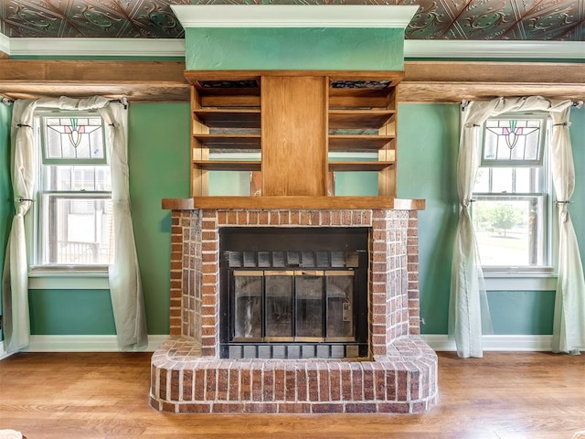 room details featuring hardwood / wood-style floors and a brick fireplace