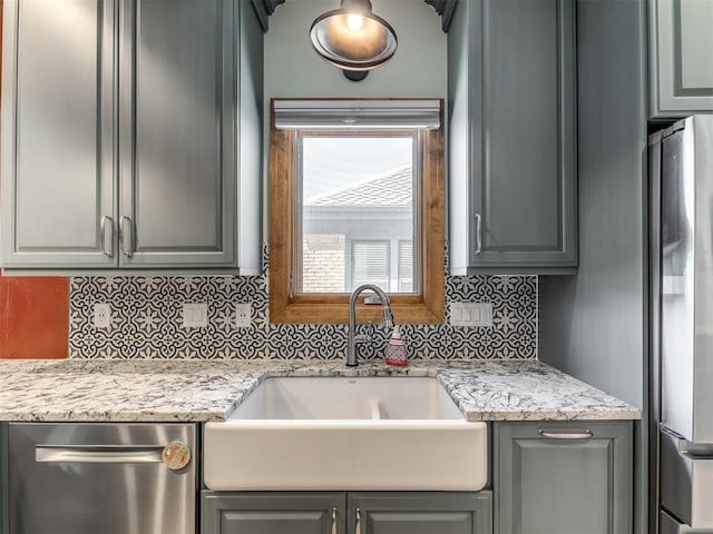 kitchen featuring appliances with stainless steel finishes, gray cabinetry, and sink