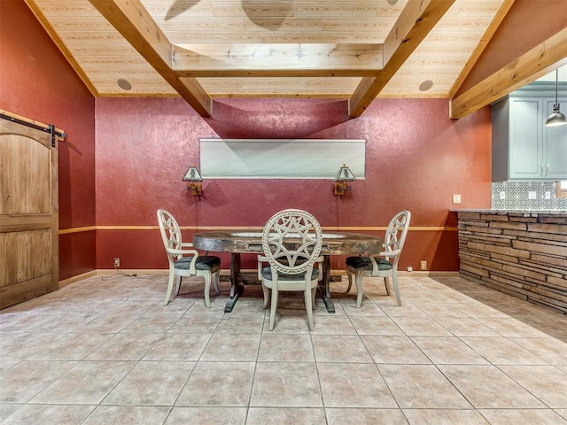 dining area with a barn door, lofted ceiling with beams, tile patterned floors, and wood ceiling