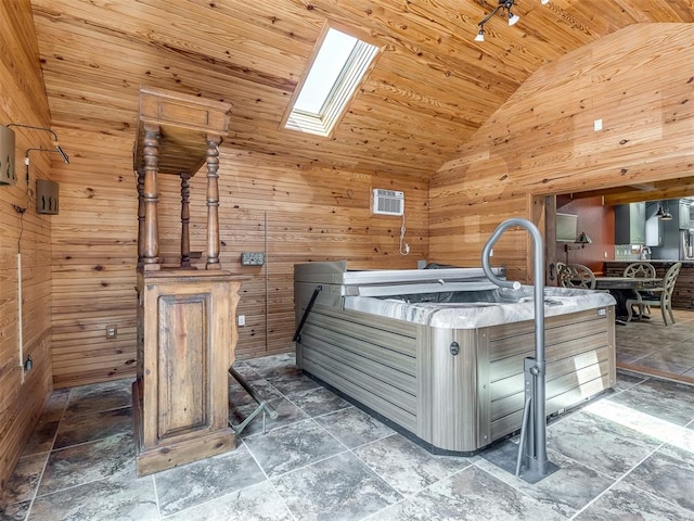 interior space featuring high vaulted ceiling, wood ceiling, wooden walls, and a skylight