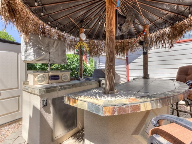 view of patio / terrace featuring an outdoor kitchen and an outdoor wet bar