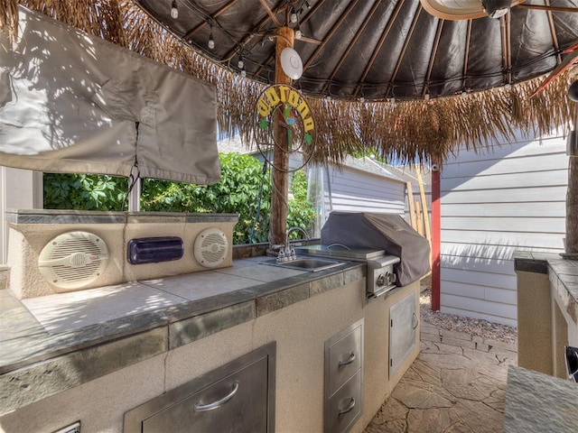 view of patio featuring a grill, area for grilling, and sink