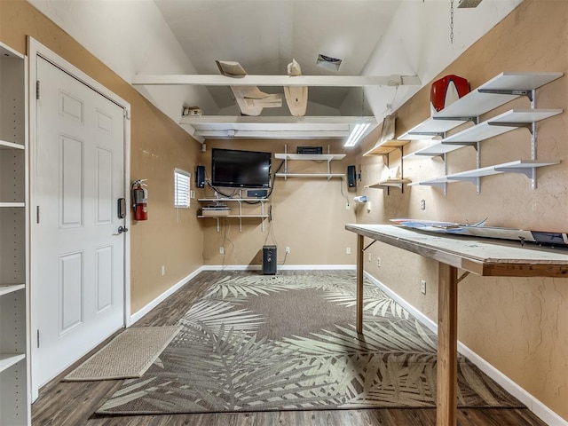 recreation room with a workshop area, hardwood / wood-style floors, and lofted ceiling