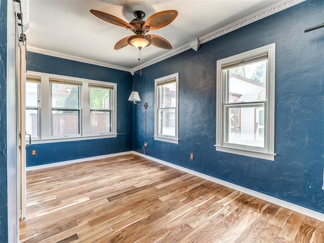 unfurnished room featuring wood-type flooring, ceiling fan, and ornamental molding