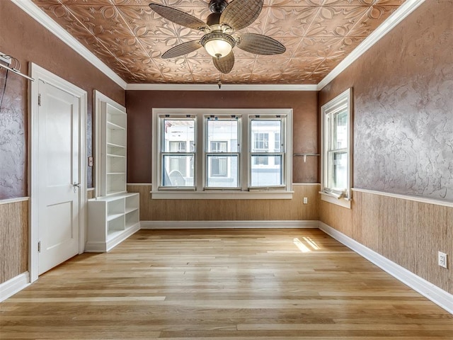 spare room featuring ceiling fan, light hardwood / wood-style floors, and crown molding