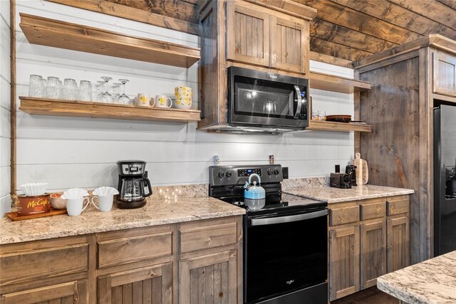 kitchen with stainless steel appliances and light stone counters