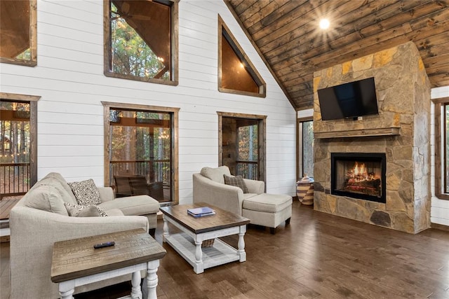 living room featuring wooden walls, high vaulted ceiling, wooden ceiling, a fireplace, and dark hardwood / wood-style floors