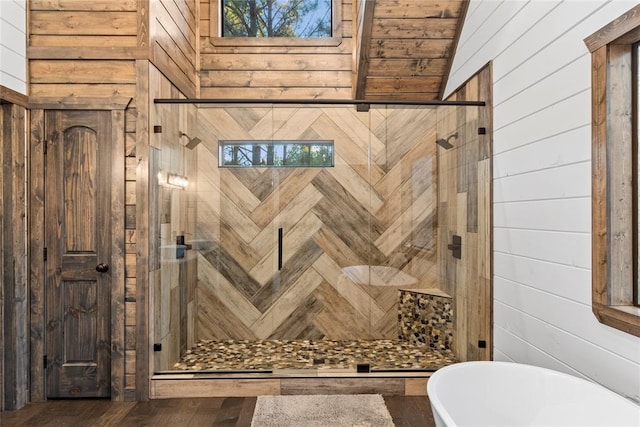 bathroom with wood walls, lofted ceiling, and shower with separate bathtub