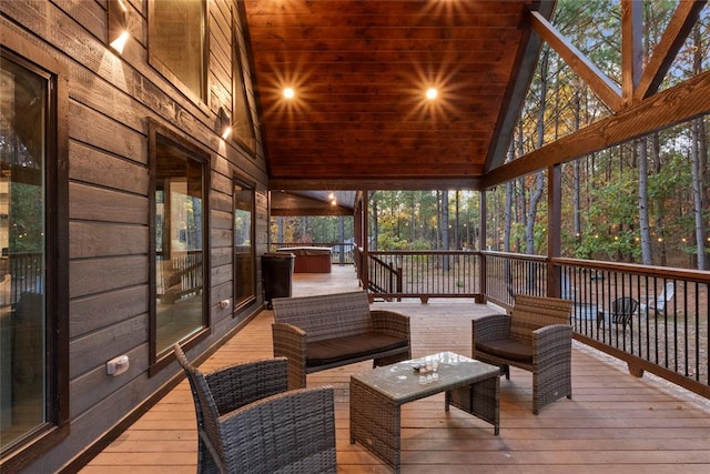 wooden deck featuring a jacuzzi and an outdoor living space