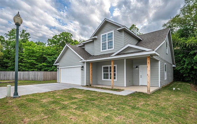 view of front of home with a garage, a porch, and a front yard