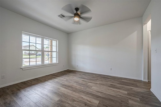 spare room with ceiling fan and dark hardwood / wood-style flooring