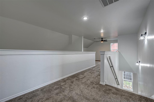 interior space featuring carpet flooring, vaulted ceiling, and plenty of natural light