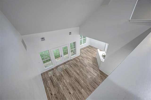 living room featuring light hardwood / wood-style flooring and high vaulted ceiling