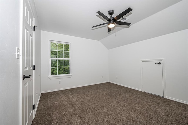 bonus room featuring ceiling fan, dark carpet, and lofted ceiling