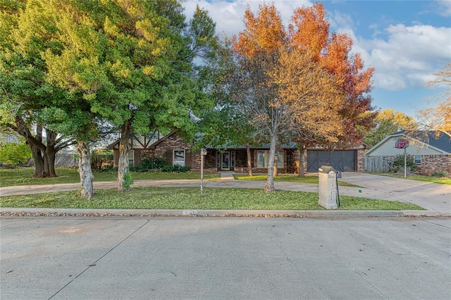 view of front of property with a garage and a front yard