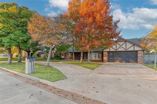 view of front of property featuring a front yard and a garage