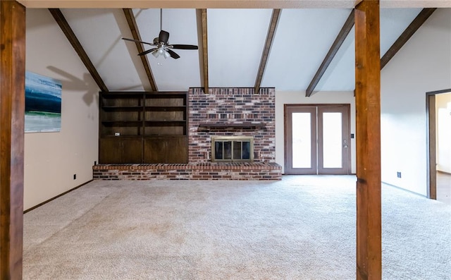 unfurnished living room with carpet flooring, ceiling fan, and beamed ceiling