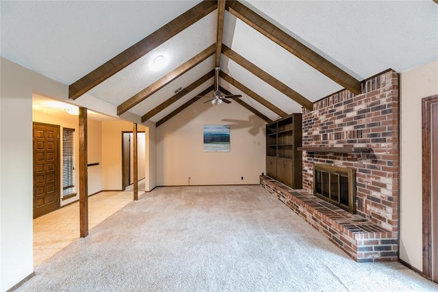 unfurnished living room featuring vaulted ceiling with beams, ceiling fan, light colored carpet, and a brick fireplace