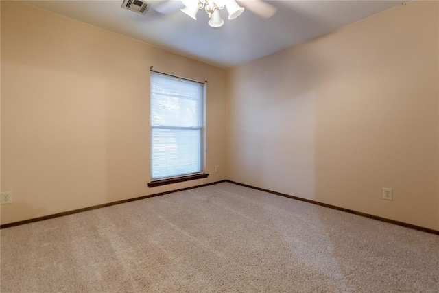 carpeted spare room with ceiling fan