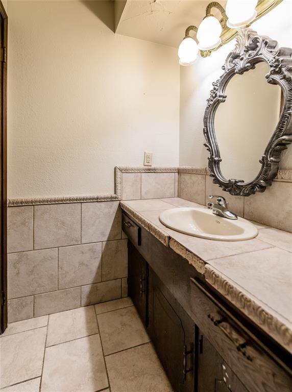 bathroom featuring tile patterned floors, vanity, and tile walls