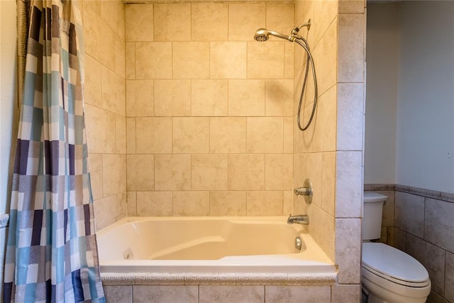 bathroom with shower / tub combo and toilet