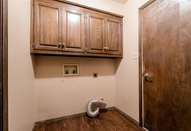 washroom featuring hookup for an electric dryer, dark hardwood / wood-style flooring, cabinets, and washer hookup