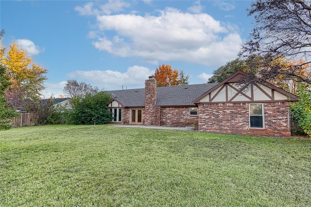 rear view of house featuring a lawn