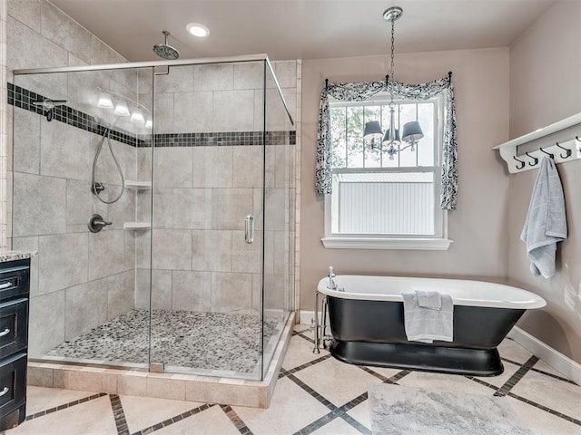 bathroom with tile patterned flooring, a notable chandelier, vanity, and independent shower and bath