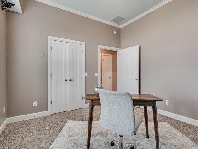 carpeted office space featuring crown molding