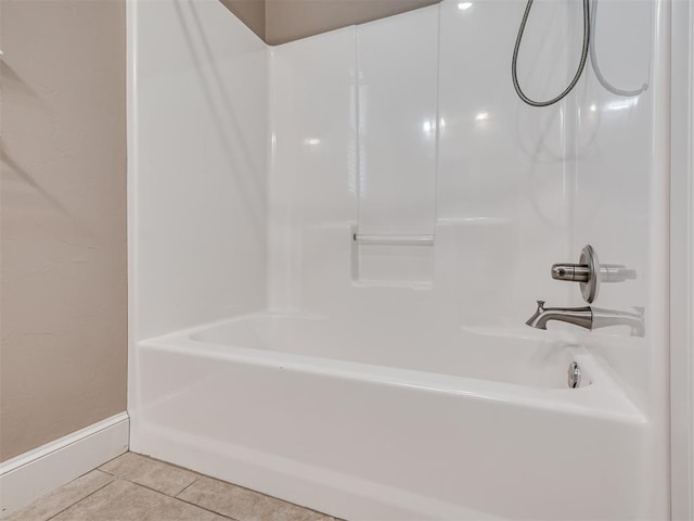 bathroom with tile patterned floors and shower / washtub combination