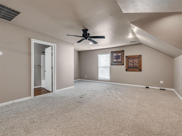 additional living space featuring ceiling fan, carpet, and lofted ceiling