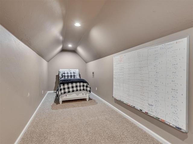 unfurnished bedroom with carpet flooring and vaulted ceiling