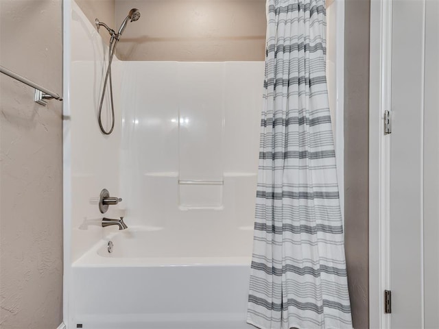 bathroom with shower / bath combo with shower curtain