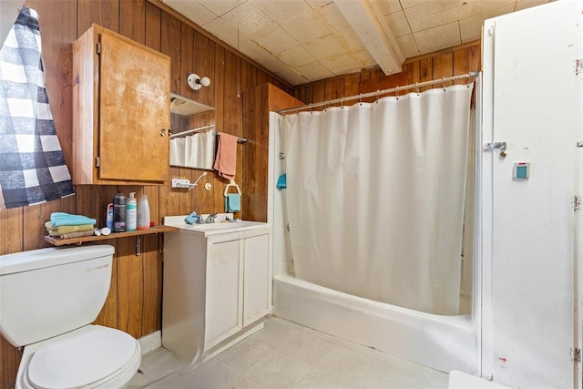 full bathroom with vanity, toilet, shower / tub combo with curtain, and wood walls