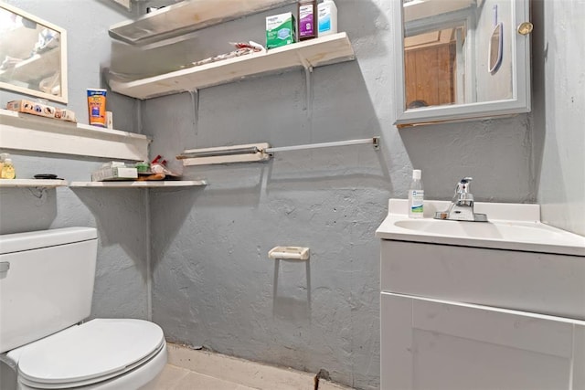 bathroom with vanity, tile patterned floors, and toilet