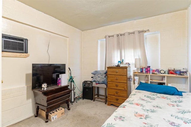 carpeted bedroom featuring a wall unit AC