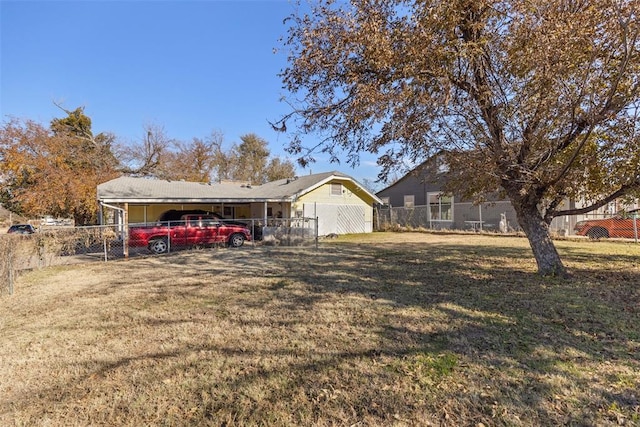 view of front of property featuring a front yard and a carport