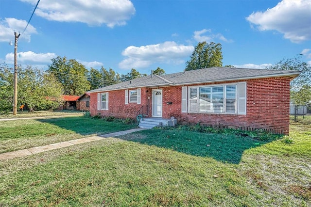 single story home featuring a front lawn