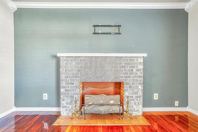 interior details with a fireplace, wood-type flooring, and ornamental molding