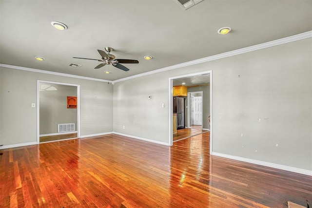 unfurnished room featuring hardwood / wood-style floors, ceiling fan, and crown molding