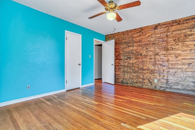 spare room with ceiling fan and light wood-type flooring