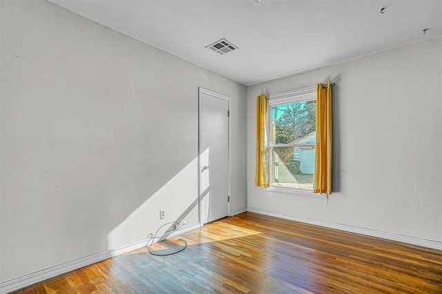 empty room with hardwood / wood-style floors