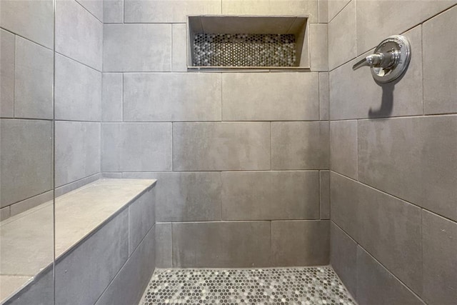 bathroom with a tile shower