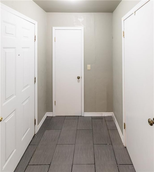 corridor featuring dark hardwood / wood-style floors