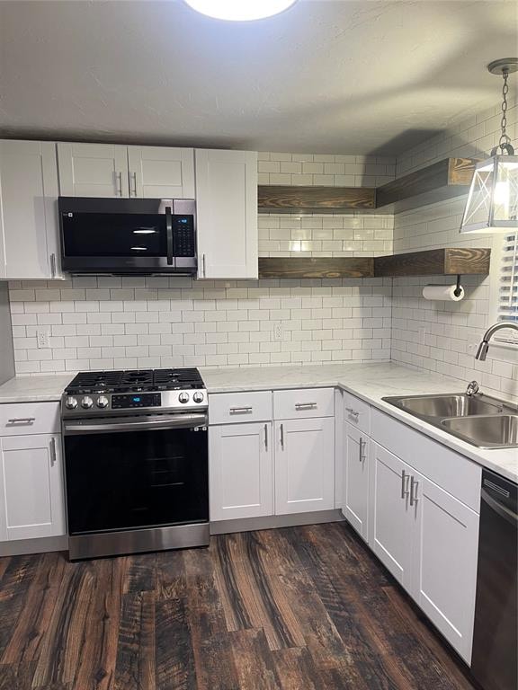 kitchen with pendant lighting, white cabinetry, sink, and appliances with stainless steel finishes