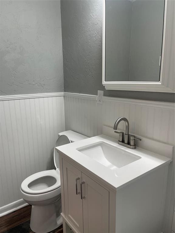 bathroom featuring vanity and toilet