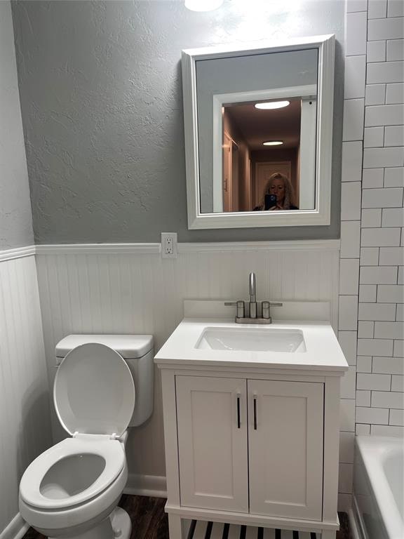 bathroom featuring vanity and toilet