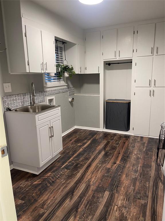 kitchen with white cabinets, dark hardwood / wood-style flooring, sink, and tasteful backsplash