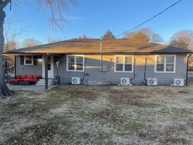 ranch-style house with ac unit, a front lawn, and a patio